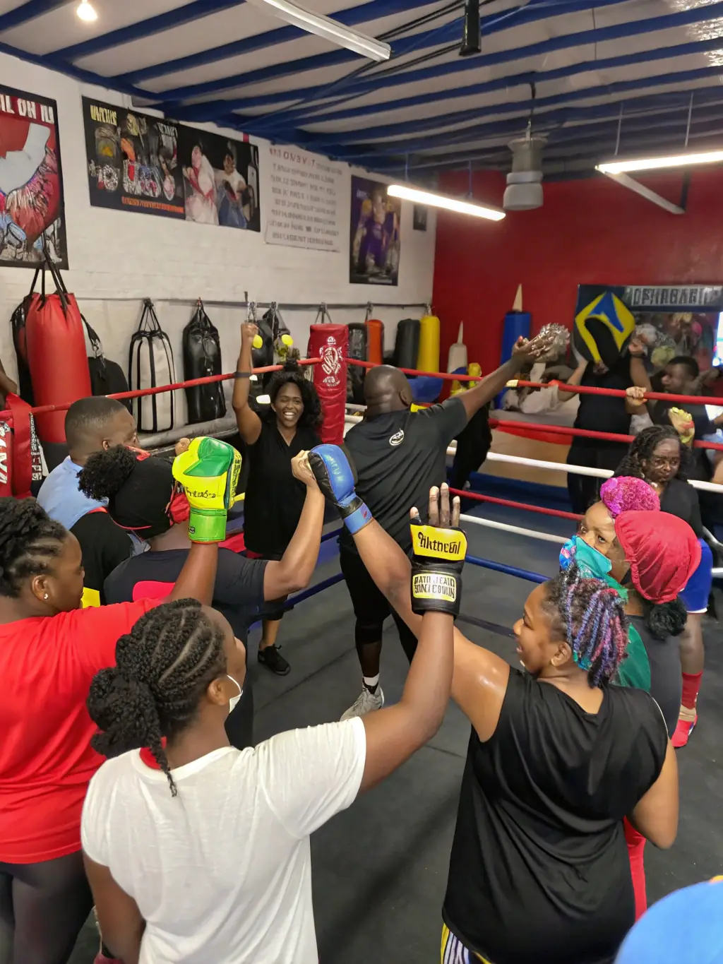 A group of diverse individuals participating in a boxing fitness class, highlighting the community aspect and the fun, energetic atmosphere of the gym.